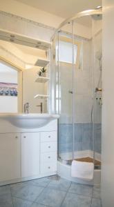 a bathroom with a sink and a shower at Mozart apartments in Baška Voda