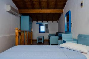 ein Schlafzimmer mit einem Bett, einem Schreibtisch und einem Stuhl in der Unterkunft Cleopatra Studios in Marathokampos