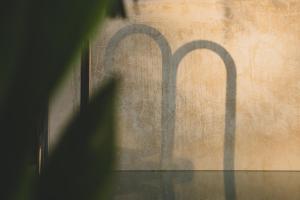 a shadow of a window with two arches on a wall at Villas Oasis, Troncones in Troncones