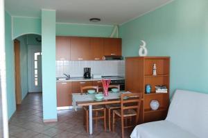 a kitchen with a table and chairs in a room at Apartments Fičur with Swimming Pool & Grill, Portorož in Portorož