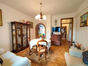 a living room with a table and chairs and a couch at Apartment La Pergola by Interhome in Roccastrada