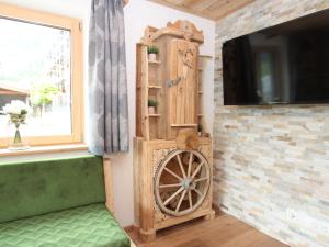 a room with a wooden wheel next to a tv at Apartment Tristner Appart by Interhome in Schwendau