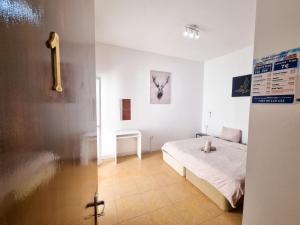 a bedroom with a bed in a white room at CityCenter Rooms Next to the Beach in Larnaka