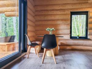 a room with two chairs and a table in a log cabin at Chalet KuŘíp by Interhome in Benešov nad Černou
