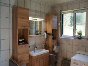 a bathroom with a sink and a mirror at Holiday Home Ferienhaus Reiter by Interhome in Rohrbach