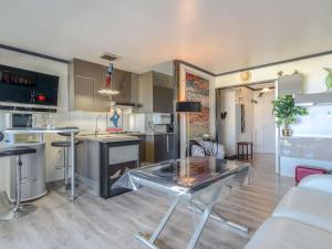 een keuken en een woonkamer met een glazen tafel bij Apartment Les Dunes by Interhome in Varaville
