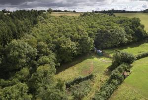 an overhead view of a house in a field with trees at Anne's Hut Monmouthshire 