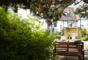 a wooden bench in a yard with a house at The Dairy Worcestershire in Eckington