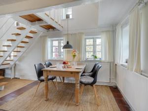 - une salle à manger avec une table et des chaises en bois dans l'établissement Holiday Home Gyril - all inclusive - 100m from the sea by Interhome, à Sønderby