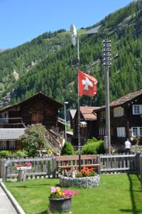 a canadian flag flying in front of a building at Apartment Wiedersehen by Interhome in Saas-Grund