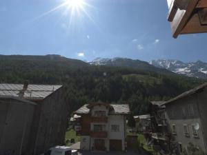 a view of a town with mountains in the background at Apartment Wiedersehen by Interhome in Saas-Grund