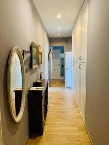 a hallway with a mirror and a sink at 1 Bedroom Lux Apartment Center Vincent in Wrocław