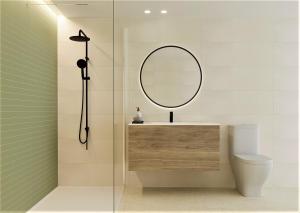 a bathroom with a mirror and a toilet at ATICO BOHIO premium in Benicàssim +37 photos