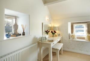 a white room with a desk and a window at Winsmore Cottage in Bakewell