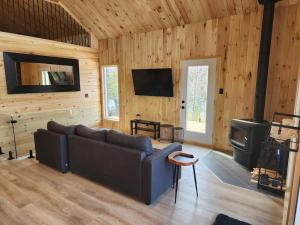 uma sala de estar com um sofá e um fogão em Spa calme au sommet em Saint Come
