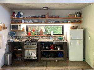 a small kitchen with a stove and a refrigerator at La Molicie, Achiras Arriba in San Javier