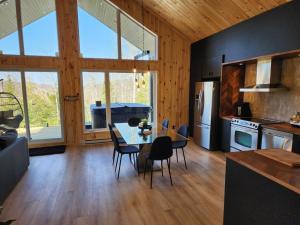 a kitchen and dining room with a table and chairs at Spa calme au sommet in Saint Come