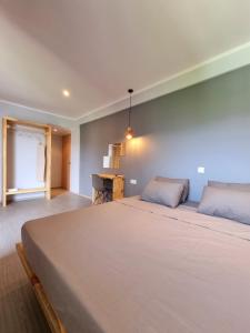 a bedroom with a large bed and a desk at Hotel Karagiannis in Limenaria