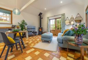 a living room with a couch and a table at Inkpen Cottage in Robertsbridge