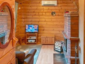 a living room with a television and a fireplace at Holiday Home Naalitupa by Interhome in Saariselka +17 photos