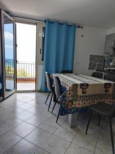 a dining room with a table and chairs and a balcony at Casa Josè Suite Mare in Palermo +22 photos