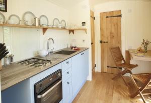 a kitchen with a sink and a stove at Rowan Retreat in Johnby
