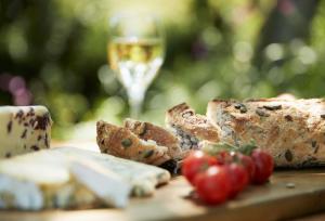 a table with bread and a glass of wine at Rowan Retreat in Johnby