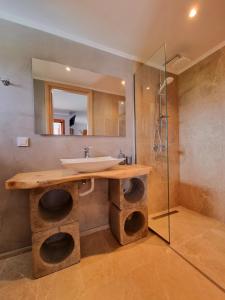 a bathroom with a sink and a mirror at Hotel Karagiannis in Limenaria