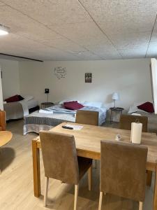 Habitación con mesa de madera y 2 camas en kabyssen en Viborg