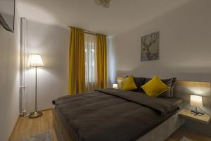 Luxury 2 bedroom holiday apartment في بيتشتي: غرفة نوم بسرير كبير مع مخدات صفراء