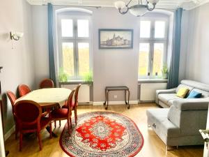 a living room with a table and chairs and a couch at 1 Bedroom Lux Apartment Center Vincent in Wrocław