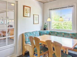 - une salle à manger avec une table et des chaises en bois dans l'établissement Holiday Home Aku - 24km from the sea in Western Jutland by Interhome, à Højer