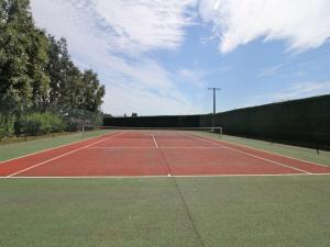 a tennis court with a net on top of it at Studio Le studio by Interhome in Saint-Jouan-des-Guérets