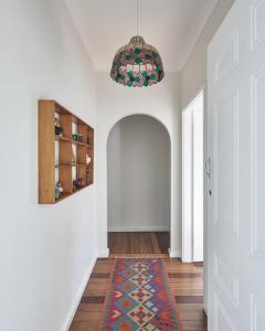 a room with a hallway with a rug on the floor at The Bakers Cottage - Crescent Head in Crescent Head