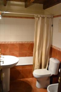 a bathroom with a toilet and a sink at Encantadora Casa adosada en Alp in Alp