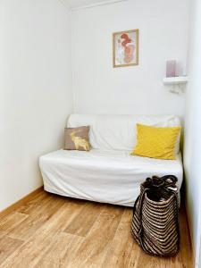 a white couch in a room with a wooden floor at Nordin Apartman in Hódmezővásárhely