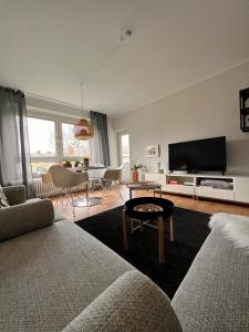 a living room with a couch and a flat screen tv at Angie´s Home in Saarlouis