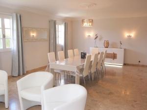 a dining room with a white table and chairs at Holiday Home La Villa by Interhome in Saint-Jouan-des-Guérets