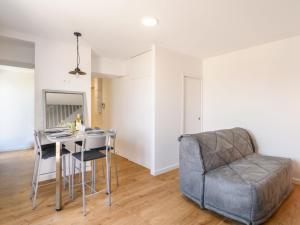 a living room with a table and a chair at Apartment Claire-4 by Interhome in Arcachon