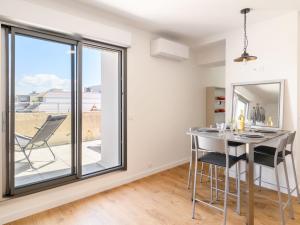 a dining room with a table and chairs and a window at Apartment Claire-4 by Interhome in Arcachon +22 photos