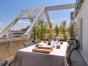 a table on a balcony with a view of the city at Apartment Claire-4 by Interhome in Arcachon