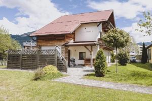 a log house with a red roof at Chalet Molly by we rent in Zell am See