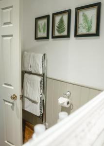 a bathroom with a mirror and some towels at The Swan at Tarporley in Tarporley