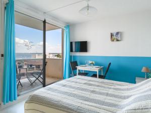 a bedroom with a bed and a view of the ocean at Studio Port Arcachon-6 by Interhome in Arcachon