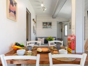 a dining room with a table with food on it at Apartment Bleuet by Interhome in Mimizan