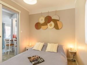 a bedroom with a bed with hats on the wall at Apartment Bleuet by Interhome in Mimizan