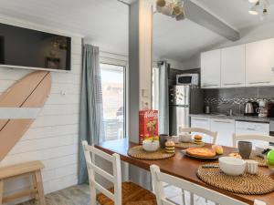 a kitchen with a wooden table with chairs and a dining room at Apartment Bleuet by Interhome in Mimizan