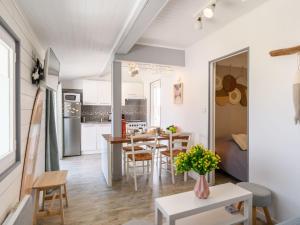 a kitchen and dining room with a table and chairs at Apartment Bleuet by Interhome in Mimizan +26 photos