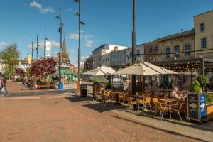 a city street with tables and chairs with umbrellas at The Garden Barn in Peterchurch