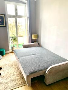 a bed sitting in a room with a window at 1 Bedroom Lux Apartment Center Vincent in Wrocław